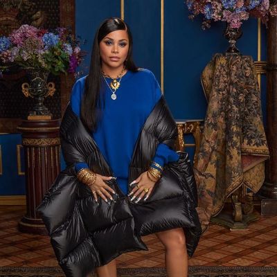 Lauren London is wearing a blue top with black jacket in the picture.